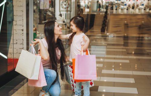 young-mother-and-daughter-holding-shopping-bags-shopping-in-the-mall-family-shopping