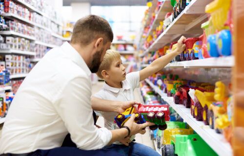 a-dad-with-a-small-child-is-shopping-at-a-childrens-store