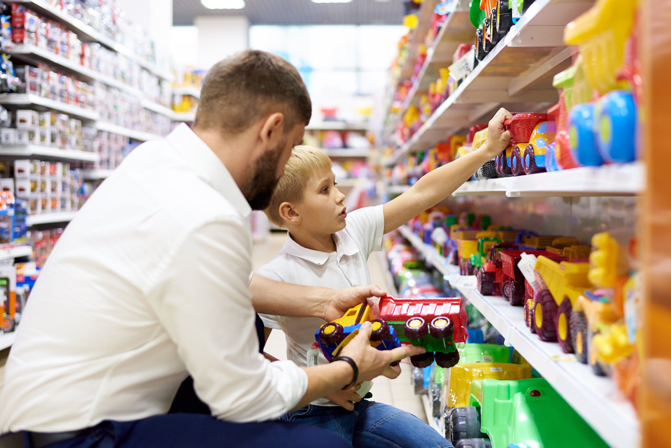 a-dad-with-a-small-child-is-shopping-at-a-childrens-store