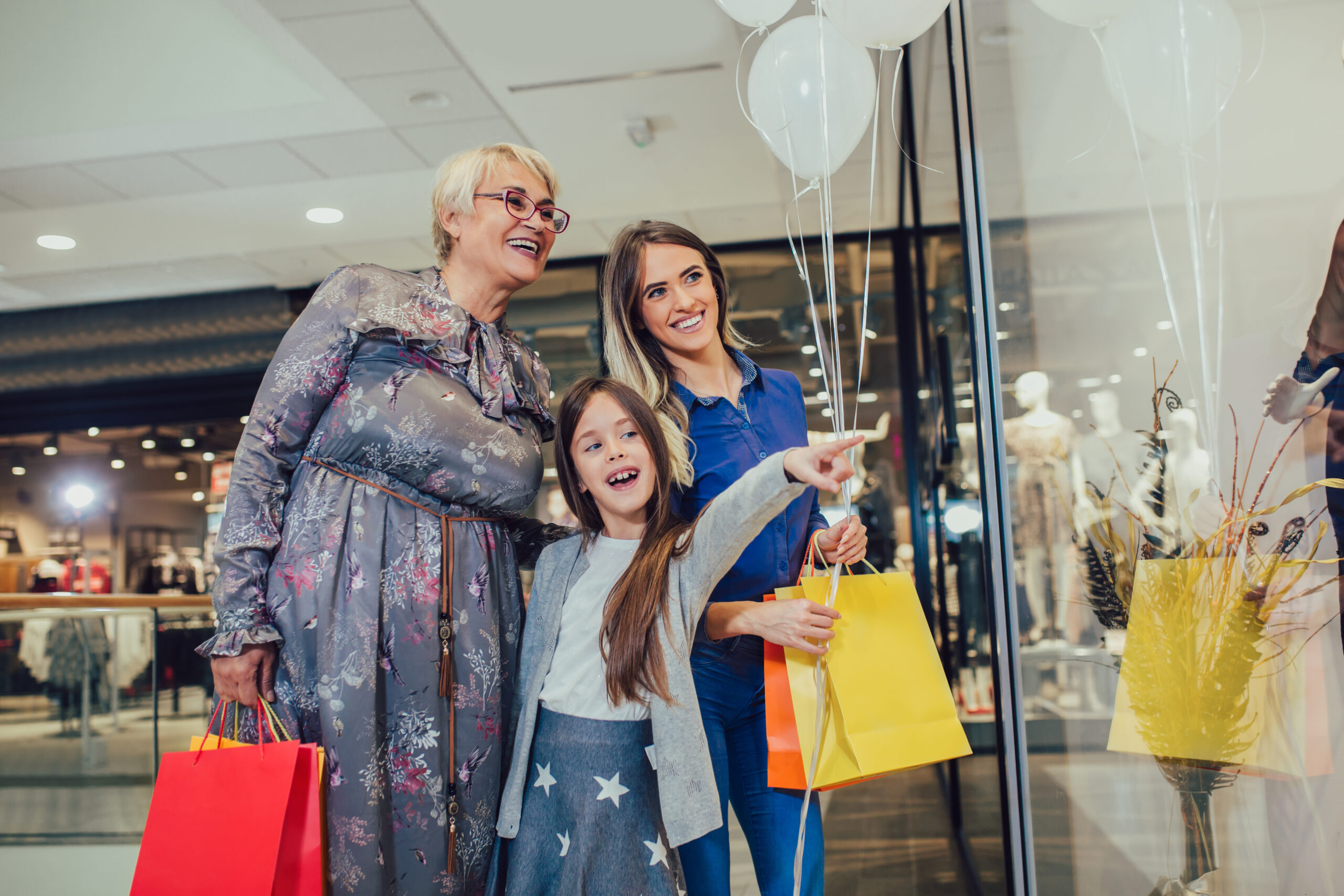 mother-adult-daughter-and-granddaughter-in-shopping-mall-together
